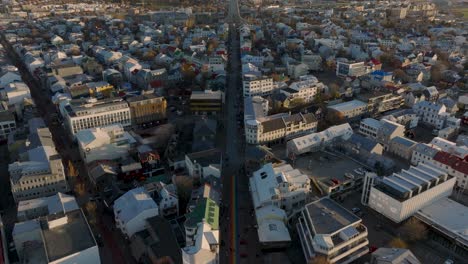 Capital-Reykjavik-city-revealing-Hallgrimskirkja-church-in-centre,-Rainbow-road,-aerial