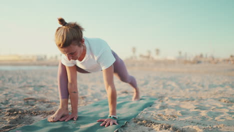 Healthy-woman-on-mat-doing-warmup-exercise.