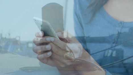 Animation-of-hands-of-caucasian-woman-using-smartphone-over-seascape