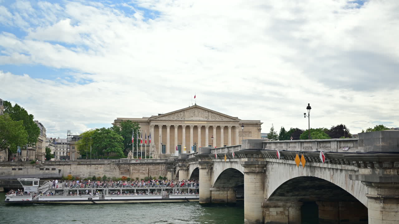 A boat full of people moving under the Concorde bridge in Paris, France