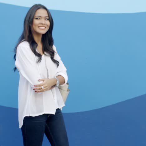 Glamorous-Young-Woman-Standing-At-The-Wall