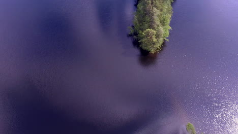 beautiful drone video of two small capes in a finnish forest lake