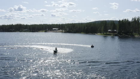 Aerial-view-of-young-men-enjoying-life-while-riding-on-a-ringo-and-jet-ski