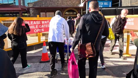 pedestrians crossing road near queen victoria market