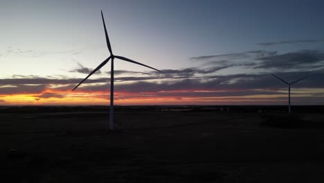 Spinning-windmills-against-an-orange-sunset-on-the-horizon-in-Western-Australia