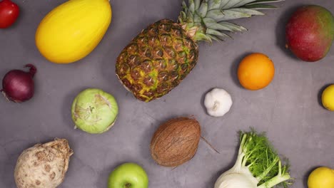 healthy lifestyle pattern made of blinking fresh organic fruits and vegetables on dark background. stop motion