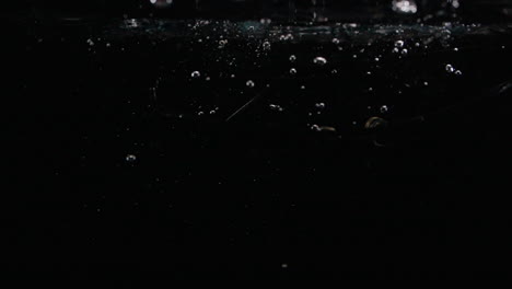 slow motion sunglasses drop in water with bubbles lost forever