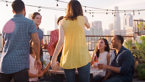 friends gathered on rooftop terrace to celebrate birthday with city skyline in background