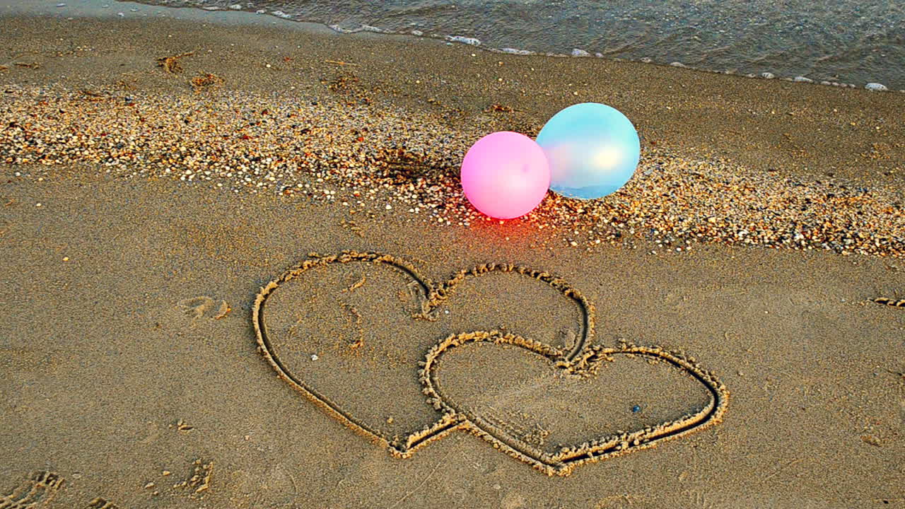 Two hearts on the beach. The loving hearts