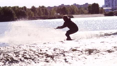 extreme rider jumping on wakeboarding on city river. extreme life style