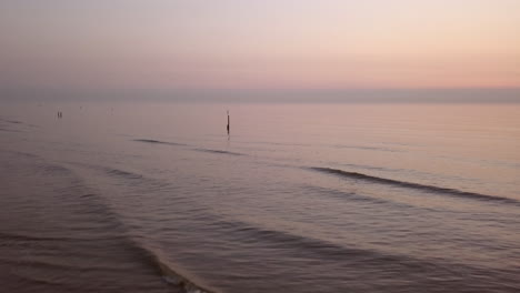 aerial shot of a calm northsea beach during sunset