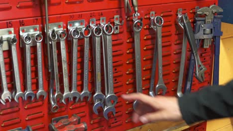 slow motion shot of an engineer removing a spanner from a tool bench in an industry workshop in stornoway on the isle of lewis, part of the outer hebrides of scotland