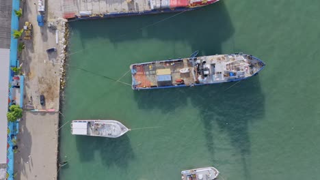 fishing boats and barge anchored at the industrial port of puerto plata in dominican republic