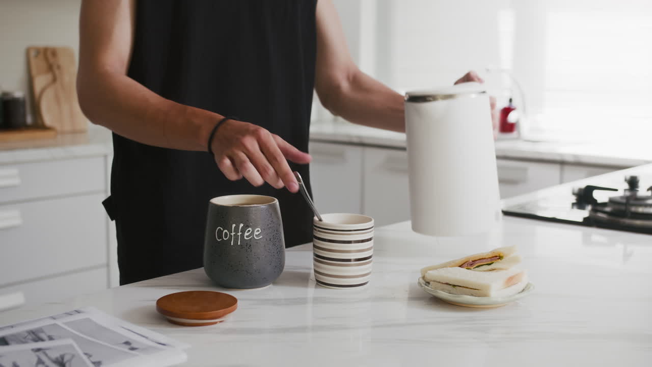 Anonymous Man Having Coffee and Sandwich for Breakfast