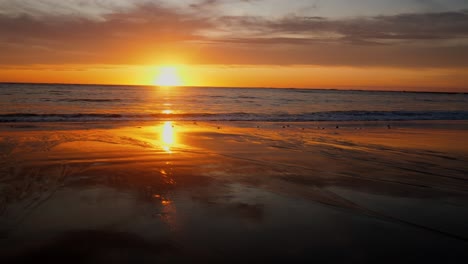 La-Puesta-De-Sol-Dorada-Se-Refleja-En-La-Orilla-Arenosa-En-Una-Exhibición-Fascinante.