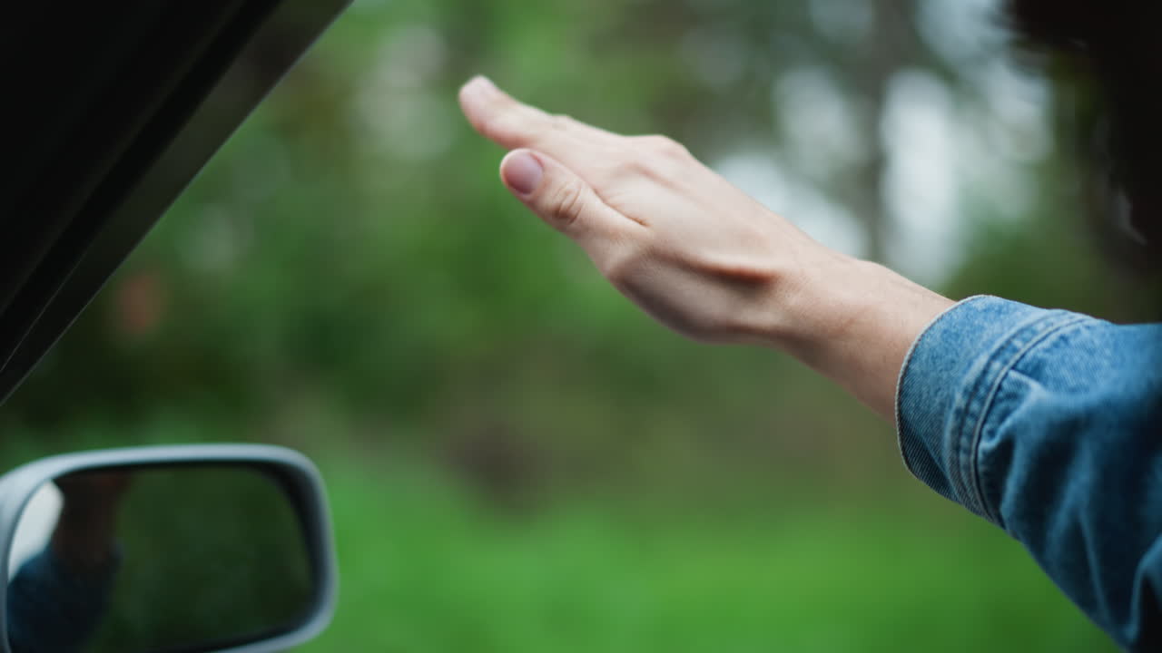 Viaggio rilassante lungo la strada, guida comoda con vista sulla natura, godendosi momenti di pace su una strada panoramica, esperienza di viaggio informale con la mano tesa fuori dal finestrino verso la lussureggiante vegetazione circostante