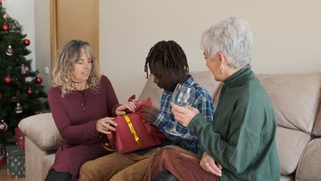family opening gifts at christmas