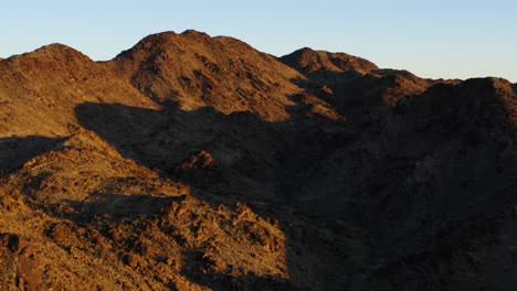 sunny day cast shadow over mountains at red cloud mine, arizona, usa, aerial