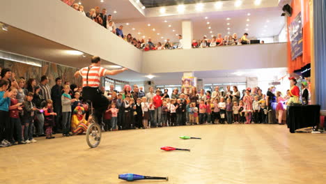 clown riding a unicycle