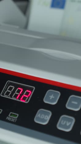 close-up of a money counting machine