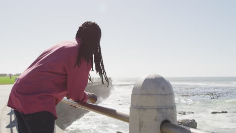 Video-of-african-american-man-looking-at-sea-on-sunny-day