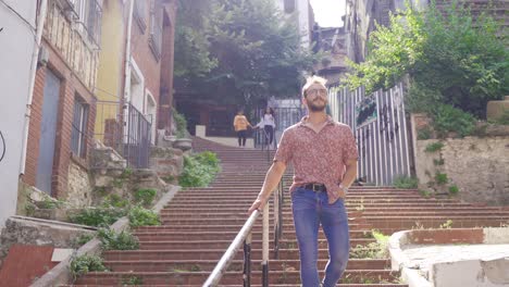 young man walking on historic street.