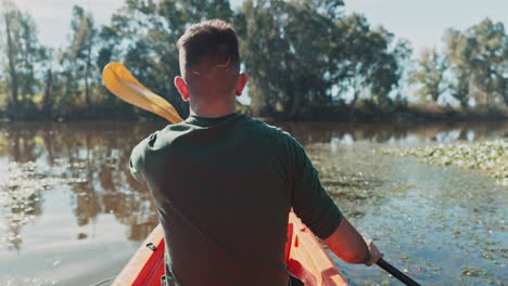 kayak, lake and back view of man on an adventure