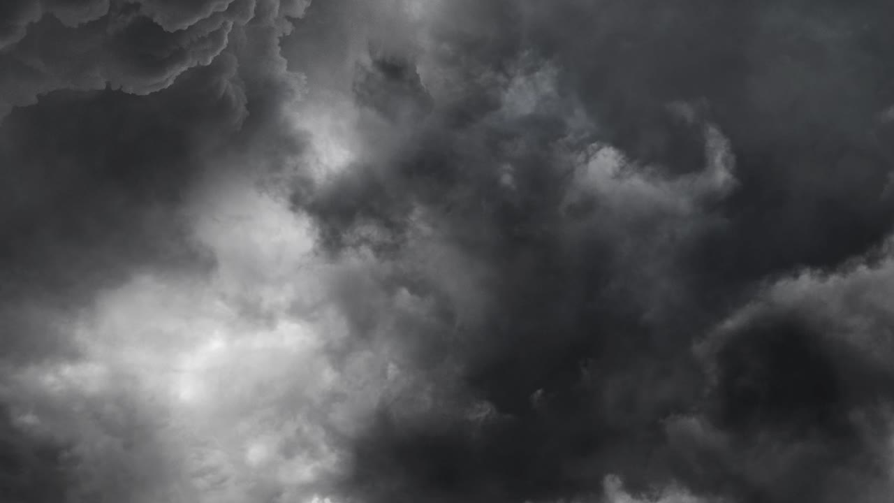 lightning flashes within a storm of clouds before a rainstorm