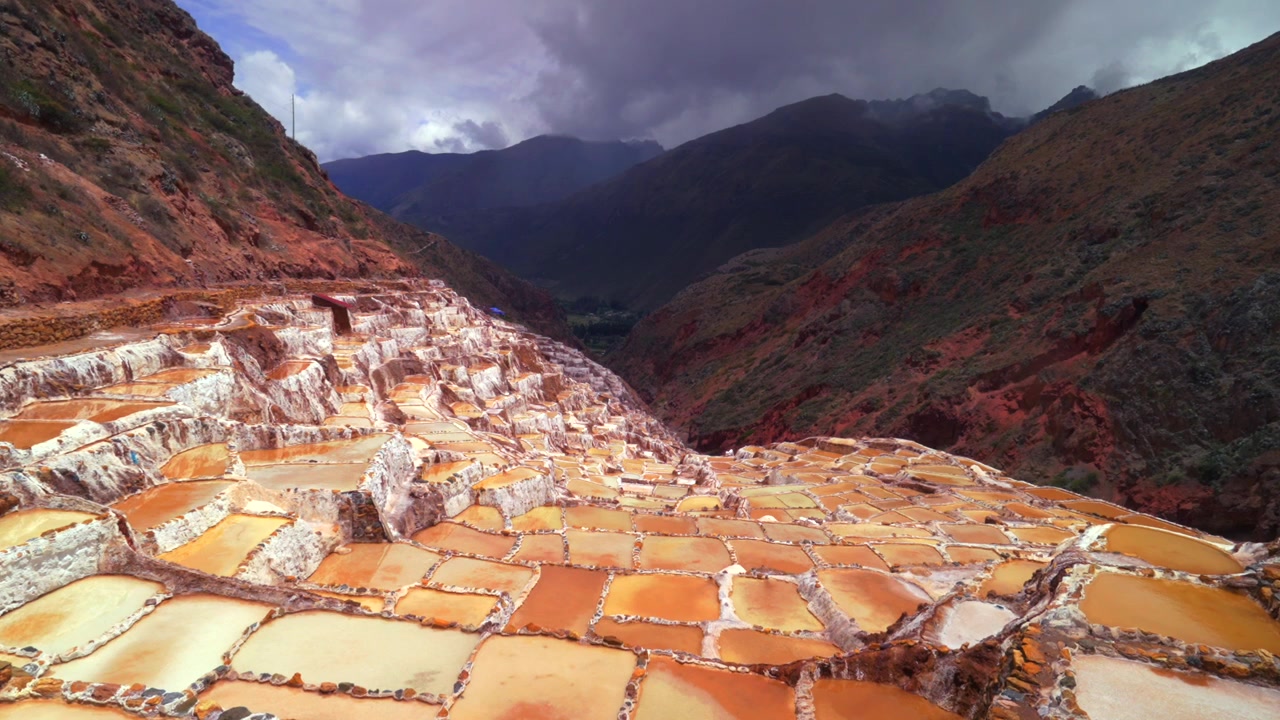 Saline di Maras, terrazze della Valle Sacra, panoramica Perù, regione di Ollantaytambo Cusco, Salineras de Maras, stagione delle piogge, soleggiato, nuvoloso, paesaggio delle Ande peruviane, Monte Moray Chicón Ancopacha, zoom avanti.