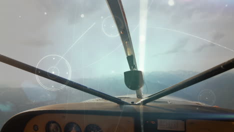 glowing network of connections against front view of dashboard of private aircraft