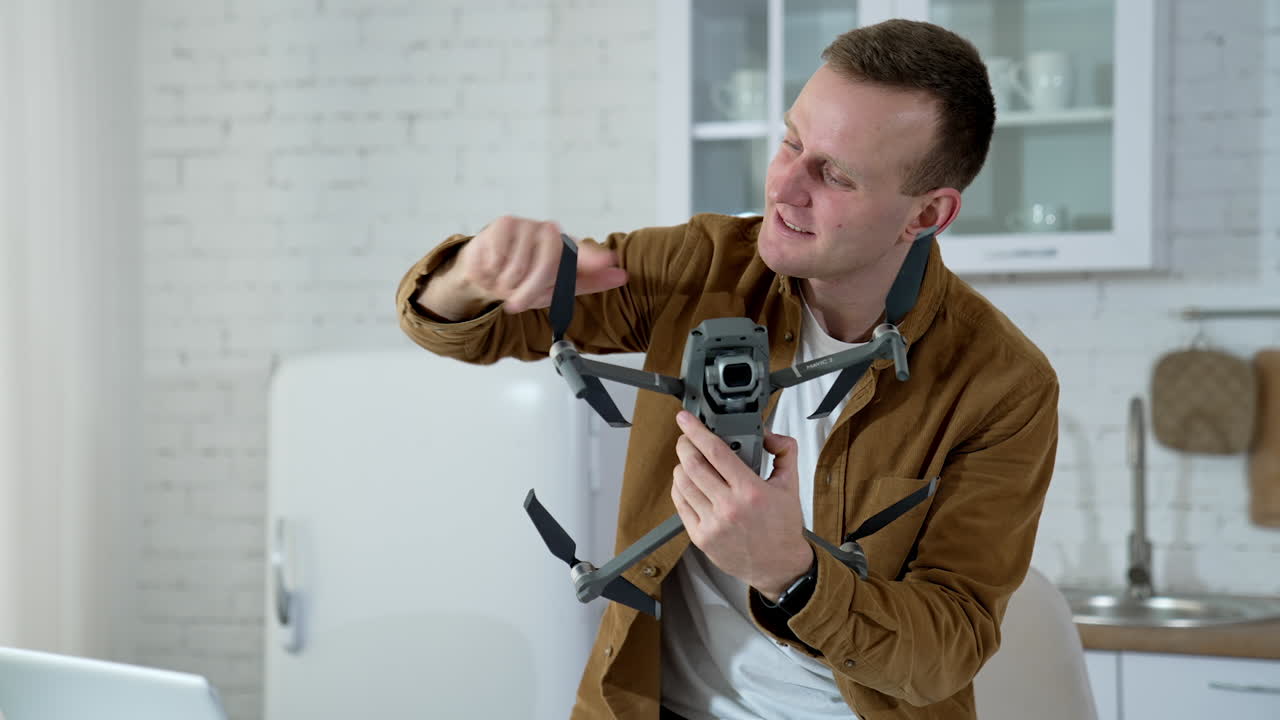 Man holding footage equipment. Young man holding drone for shooting video