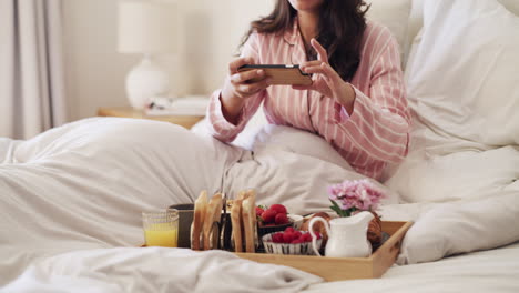 Female-influencer-taking-a-picture-of-breakfast