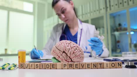 doctor and 'suicide prevention' blocks with brain model