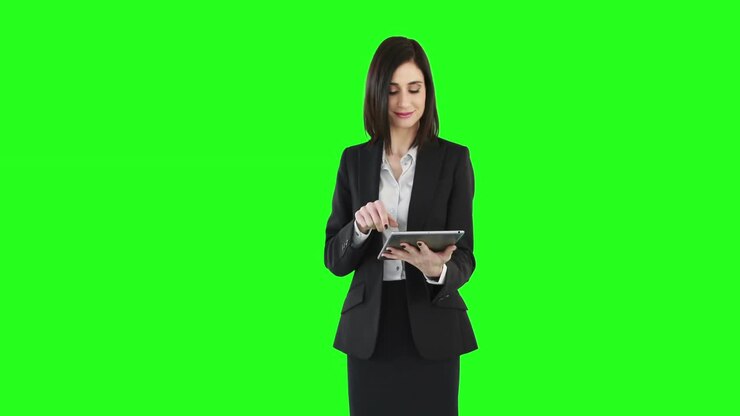 Business woman standing and using a tablet