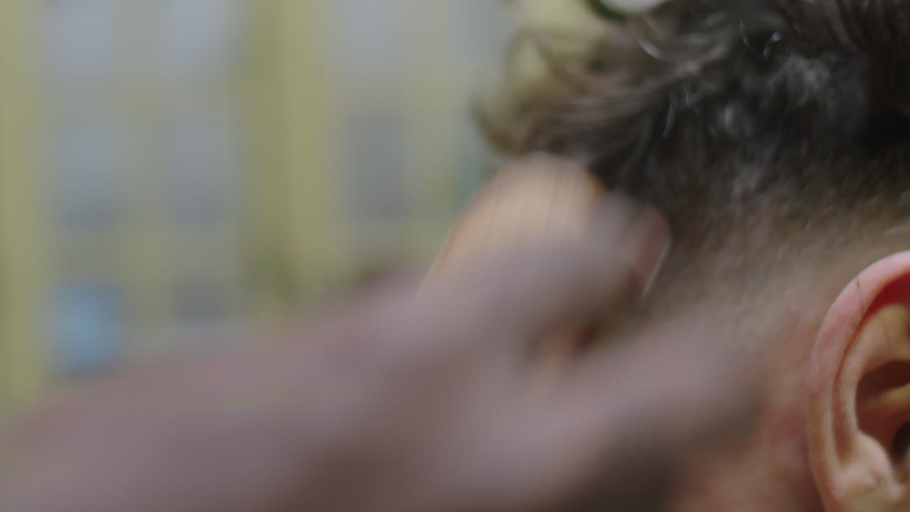 Hands of Barber Shaving Neckline of Client with Hair Trimmer