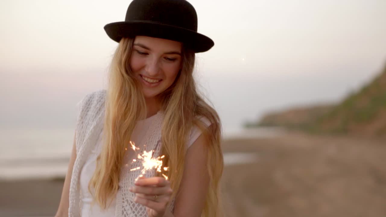 Happy Woman at the Beach Sunset with Sparkler