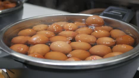 boiling eggs in a metal bowl