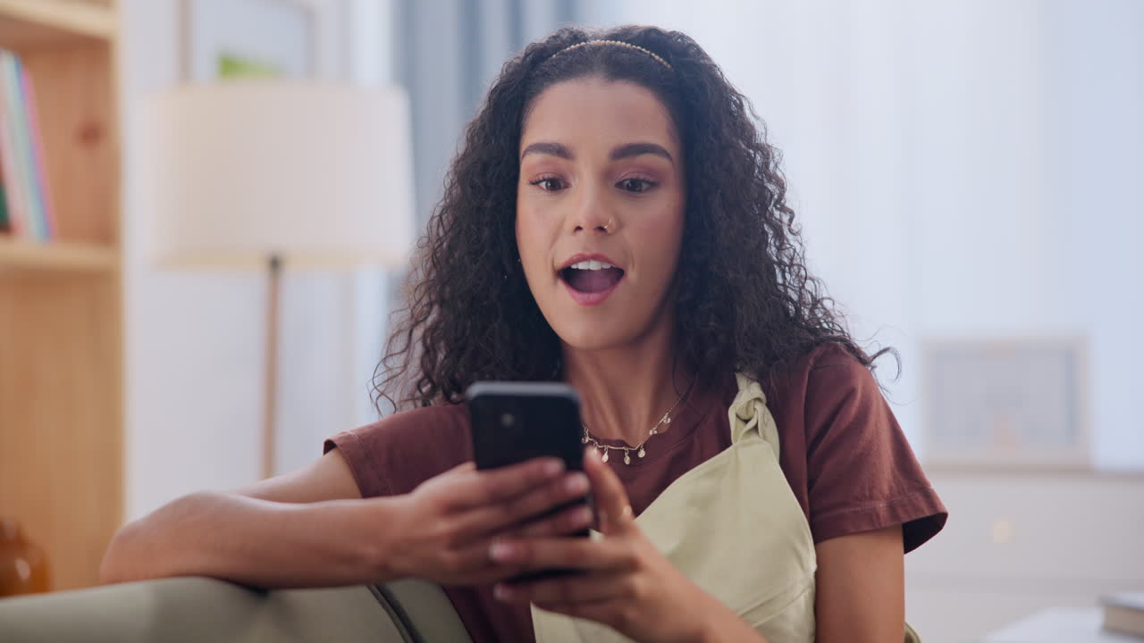 Woman Celebrating Success on Smartphone