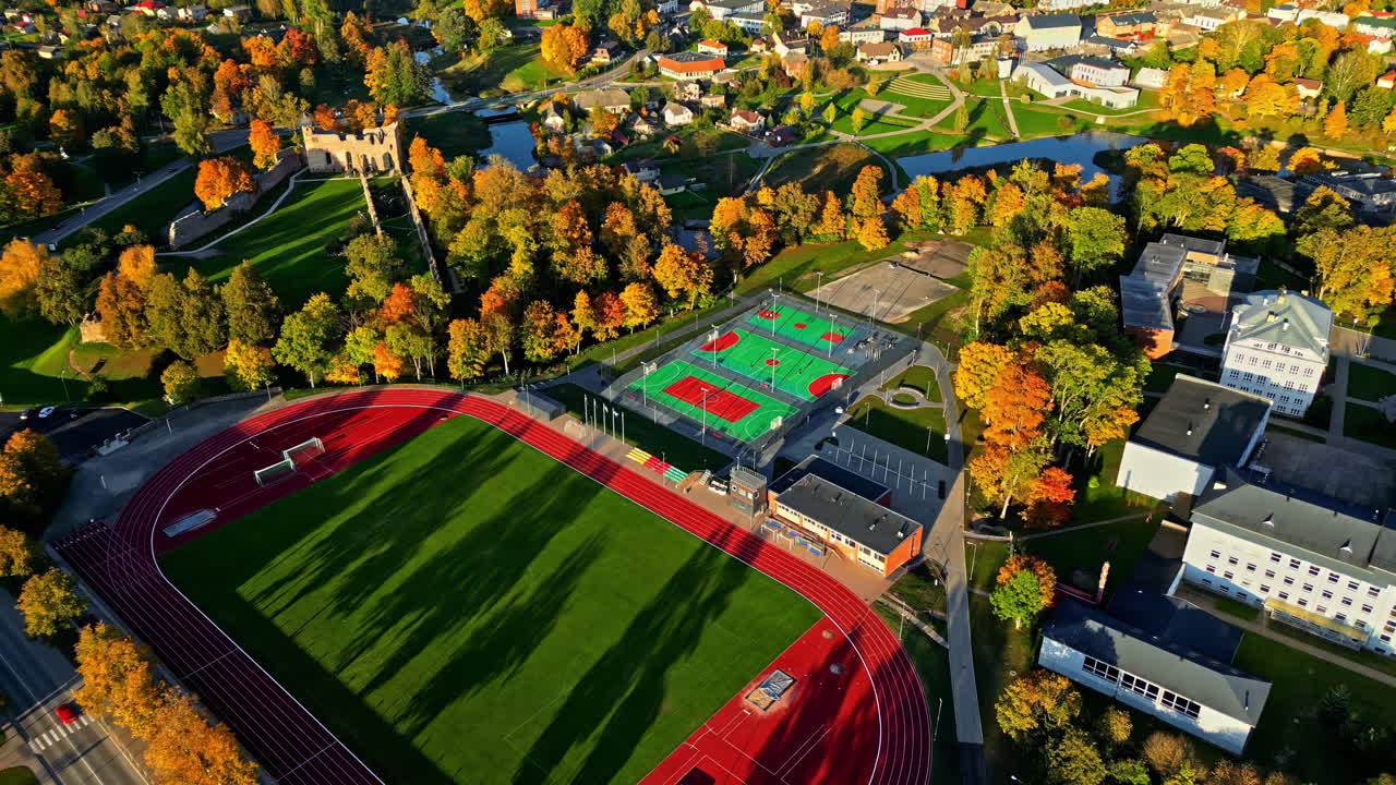 Dobele Stadium Near Dobele Castle Ruins During Autumn In Latvia. aerial shot