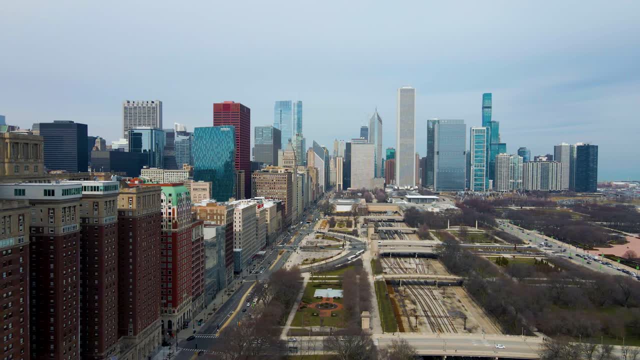 aerial footage captures skyline of downtown Chicago from a bird's-eye view. The sprawling cityscape and towering skyscrapers are full of grandeur energy related to architecture, tourism and cityscapes