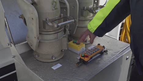 Ships-crew-pushing-stop-button-after-completed-charging-process-of-electric-ship-Hjellestad---Closeup-slow-motion-handheld