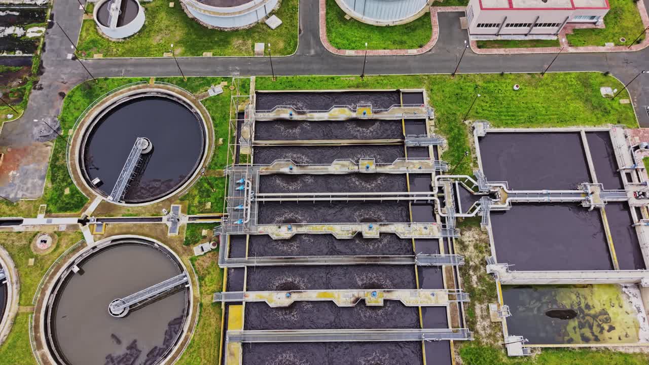 Wastewater treatment facility at work during midday in a large city