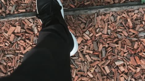 a cinematic top-down shot of slow walking footsteps captured with a 35mm lens. the shallow depth of field and subtle motion, perfect for storytelling, lifestyle, or emotional visual sequences.