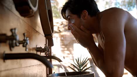 man washing face from water in cottage 4k