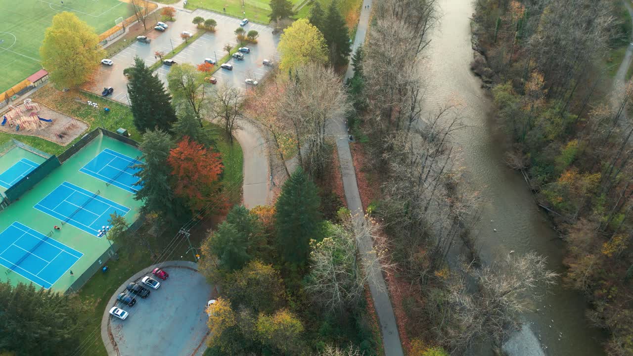 A drone shot of coquitlam river and tennis courts in gate's park, port coquitlam.