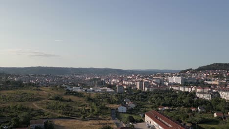 aerial descends over building cityscape of ourense spain, sky horizon