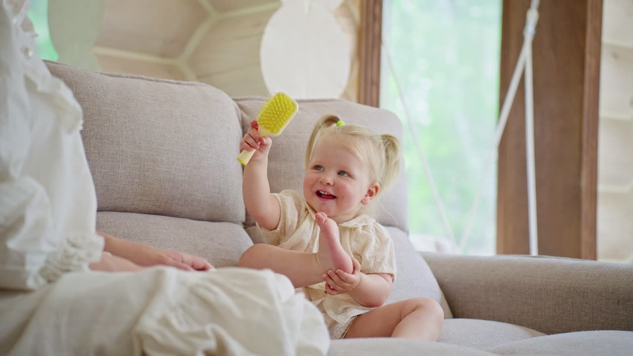 Mother and Daughter Playing on Sofa