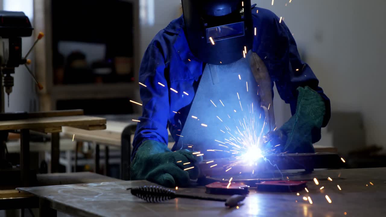 Female welder using blow torch on a rod 4k