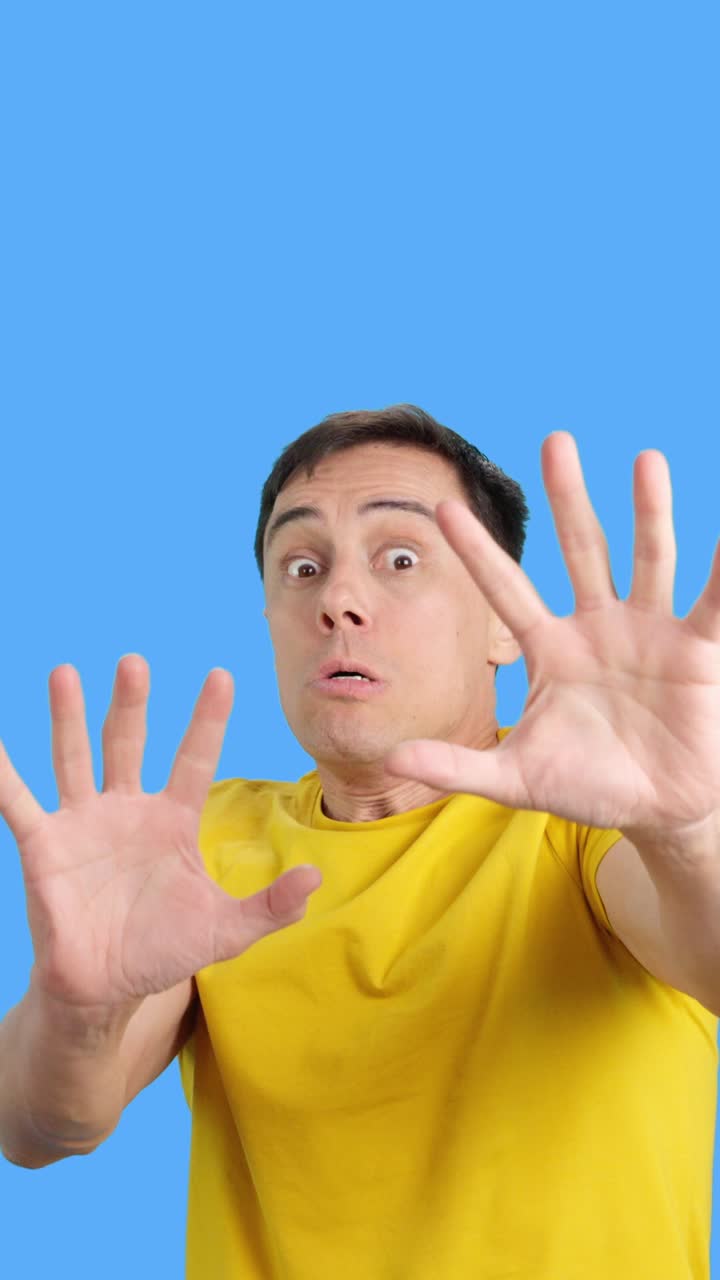 Man showing scared expression with hands up