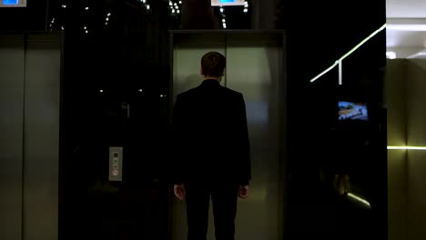 businessman in elevator at night